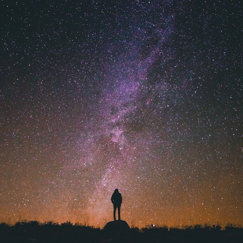 Person standing under the stars