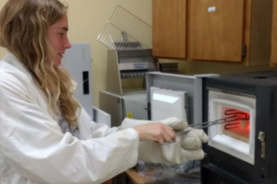 Student working with furnace in lab