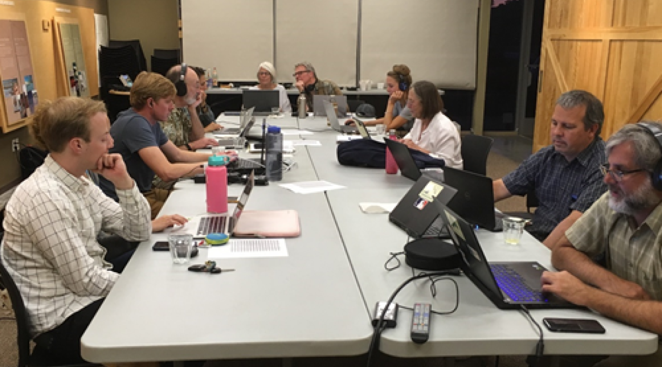 Students, faculty and citizens working around a table
