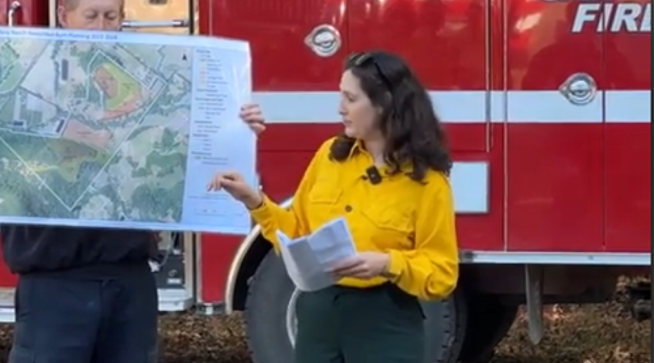Melina Hammer in front of Cal Fire Truck showing plans for prescribed fire
