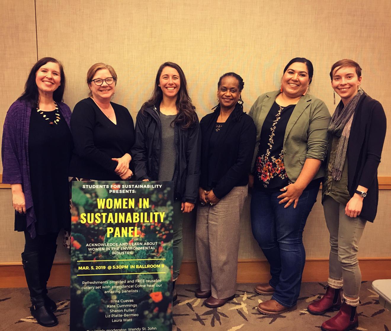 A diverse group of women engaged in a panel discussion about sustainability, highlighting the intersectional nature of environmental justice.