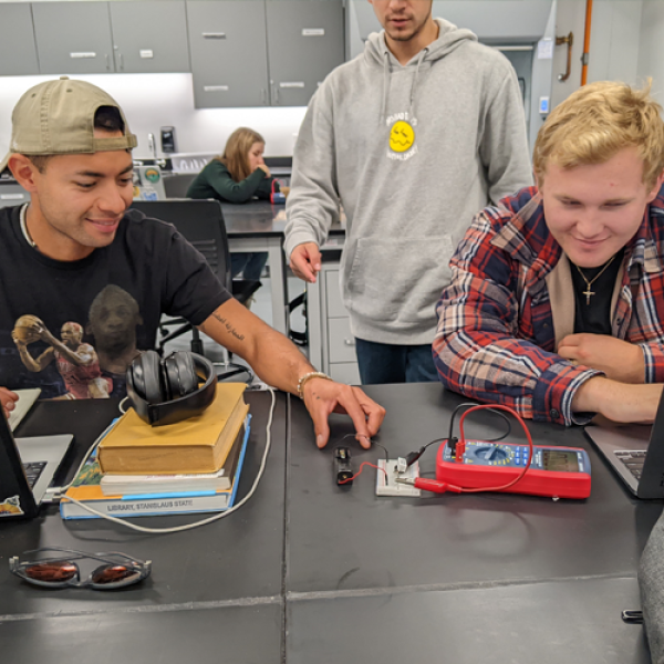 Students working with an energy-reading device