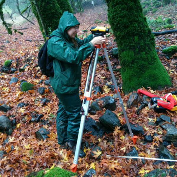 Student surveying in the field