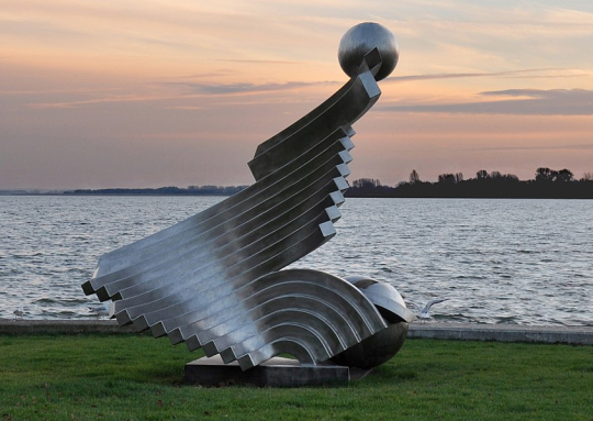 Abstract sculpture near water