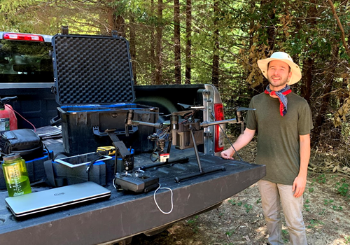 Student with drone equipment on back of truck