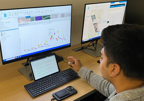 Student viewing a computer screen in the GIS lab