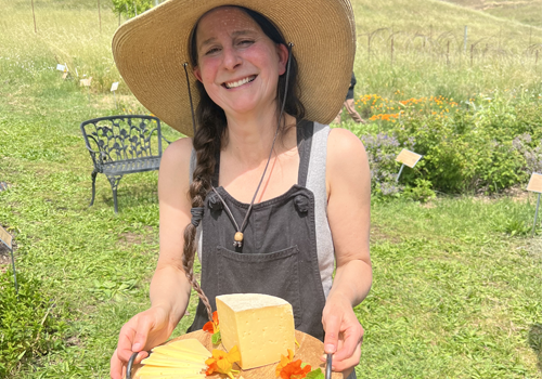 Caiti offering cheese at Green Valley Farm